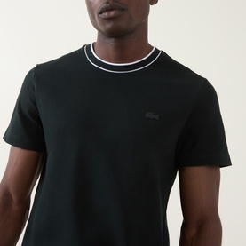 Model wearing Lacoste Crew Neck T in Dark Varech, featuring white tipped ribbed collar and tonal crocodile logo.