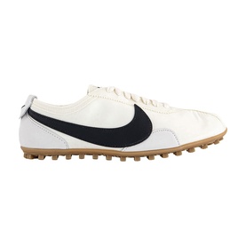 Nike Sail Black low-top trainer with navy Swoosh, leather upper, lace-up front, and tan gum rubber sole.