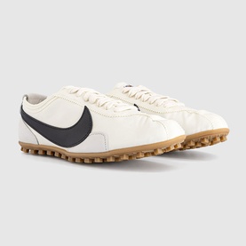 Nike trainers in sail white with black swoosh, perforated leather upper and gum rubber studded sole