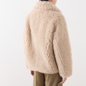 Model wearing Marella sand teddy fleece coat, back view, styled with khaki trousers