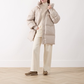 Model wearing Marella turtledove quilted puffer coat, styled with cream wide-leg trousers, ribbed turtleneck, and taupe loafers.