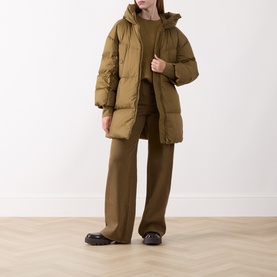 Model wearing Marella Oil Green puffer coat, styled with matching wide-leg trousers and black chunky sole shoes.