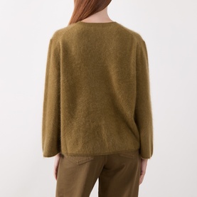 Model wearing Marella oil green wool-cashmere knit sweater, back view, styled with khaki trousers.