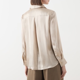 Model wearing Marella turtledove satin shirt, back view showing relaxed pleat detail, long sleeves with button cuffs, styled with khaki trousers.