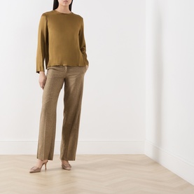 Model wearing Marella oil green acetate-silk long-sleeve shirt, styled with beige wide-leg trousers and nude heels.