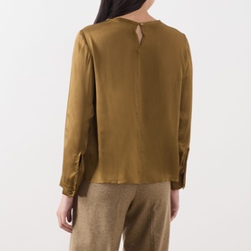 Model wearing Marella oil green satin blouse, back view, with keyhole neckline detail and long sleeves, styled with taupe trousers.