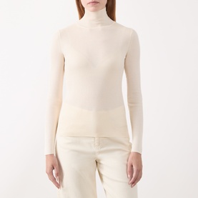 Model wearing Marella white fine-knit roll-neck top with long sleeves, styled with cream tailored trousers.