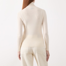 Model wearing Marella white long-sleeve turtleneck top in lyocell-wool blend, shown from behind, styled with cream trousers.