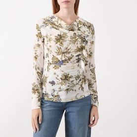 Model wearing Marella wool white floral print long-sleeve top with ruched neckline detail, styled with blue jeans.