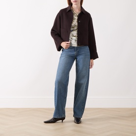 Model wearing Marella Wool White printed top, styled with dark brown cropped jacket and light blue wide-leg jeans.