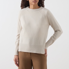 Model wearing Marella turtledove wool knit jumper with ribbed hem, cuffs and raglan shoulders, styled with tan trousers.