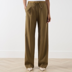 Model wearing Marella Oil Green wide-leg wool trousers with elasticated drawstring waist and front pleats, styled with white heeled mules.