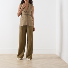 Model wearing Marella Oil Green wide-leg wool trousers, styled with a matching sleeveless belted waistcoat and cream heels.
