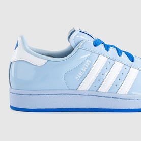 Adidas Superstar trainers in light blue patent leather with white three stripes, royal blue laces and blue sole