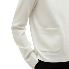 Model wearing Hobbs cream fine-knit top with patch pocket detail, styled with black trousers.