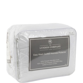 The Lyndon Company Easy Wash Quilted Mattress Protector, white, packaged in clear zip bag with label visible.