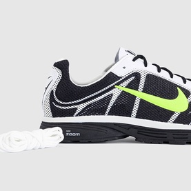 Nike trainer in black, volt green and summit white with mesh upper, lime Swoosh logo and white laces on dark rubber sole.