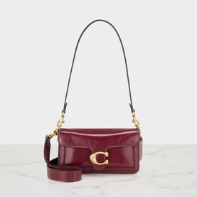 Coach dark cherry leather crossbody bag with gold C buckle hardware, single shoulder strap and detachable crossbody strap