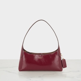 Coach dark cherry leather shoulder bag with gold-tone hardware and single top handle, small structured silhouette with zip closure