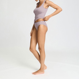 Model wearing Hanro brief in Stormy Rose, styled with matching vest top, side profile view showing smooth seamless finish.