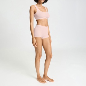 Model wearing Hanro Rosewater shorts with matching crop top, full-length front view on plain background