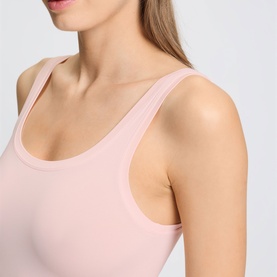 Model wearing Hanro Rosewater vest, close-up detail showing scoop neckline and wide shoulder straps in smooth ribbed fabric.