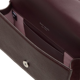 Kate Spade Blackberry Jam leather crossbody bag, open top view showing lilac interior lining, card slots and silver press-stud closure
