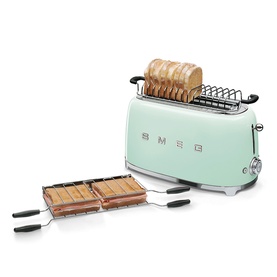 Smeg 4 Slice Long Slot Toaster in pastel green with chrome accents, shown with sandwich rack accessory and toasted bread slots filled.