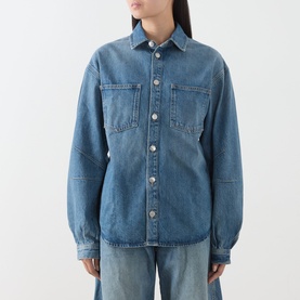 Model wearing Samsoe & Samsoe sephia blue denim shirt with chest pockets and silver buttons, styled with wide-leg jeans.