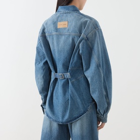 Model wearing Samsoe & Samsoe sephia blue denim shirt, back view showing belted waist detail and branded patch, styled with wide-leg denim trousers