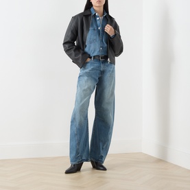 Model wearing Samsoe & Samsoe sephia blue denim shirt, styled with black leather jacket, wide-leg jeans and black ankle boots.