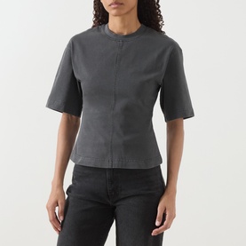 Model wearing Samsoe & Samsoe black pigment cotton T-shirt with structured seam detailing and short sleeves, styled with dark jeans.