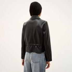 Model wearing Bash black leather jacket, back view, styled with light blue wide-leg jeans