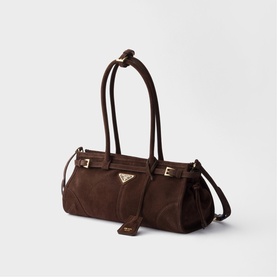 Prada dark brown suede tote bag with gold-tone triangle logo, dual top handles, buckle straps, and detachable crossbody strap