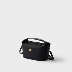 Prada black nylon crossbody bag with gold-tone triangle logo, top handle, and adjustable shoulder strap