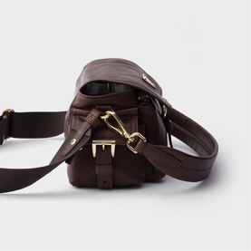 Dark brown leather crossbody bag with gold-tone buckle and clip hardware, adjustable shoulder strap, shown from rear angle