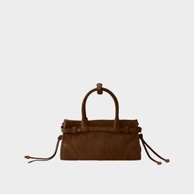 Brown suede structured tote bag with knot-detail top handles, side drawstring ties, and tan leather trim on a white background.
