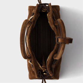 Tan suede mini bag, overhead view showing open interior, gold-tone zip pocket and hardware, with knotted drawstring closure and short handles