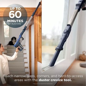 Shark PowerDetect Speed Cordless Vacuum in use reaching narrow gaps and corners with duster crevice tool attachment, up to 60 min runtime