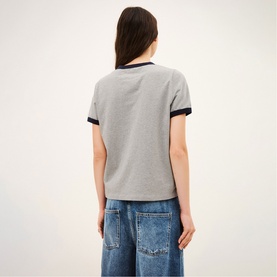 Model wearing Bash grey T-shirt with navy contrast collar and cuffs, styled with wide-leg blue jeans, back view