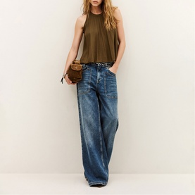 Model wearing Bash brown sleeveless ribbed tank top, styled with wide-leg blue denim jeans and a small brown crossbody bag.
