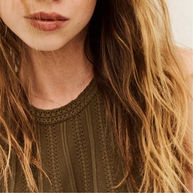 Model wearing Bash brown knit top with vertical lace-trim stripe detailing, crew neckline, close-up shot