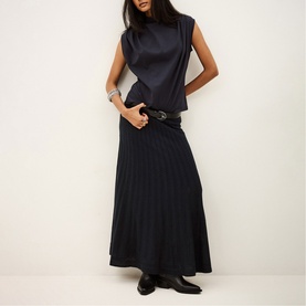 Model wearing Bash blue ribbed maxi skirt with matching sleeveless top, black leather belt and black ankle boots.