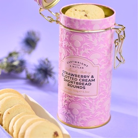 Cartwright & Butler Strawberry & Clotted Cream Shortbread Rounds in pink floral clip-top tin, shown open with biscuits on plate alongside.