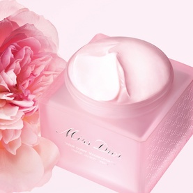 Dior Miss Dior Blooming Scent body cream in pink pot with whipped texture, styled with pink peony flower