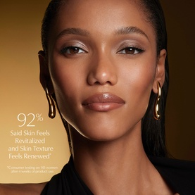 Model with glowing, smooth skin wearing gold hoop earrings, illustrating Est&eacute;e Lauder Re-Nutriv Age Reversal Recovery Cr&egrave;me results