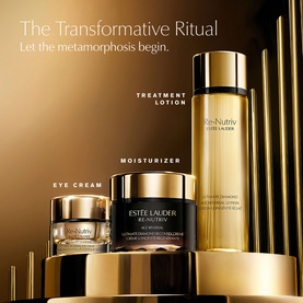 Est&eacute;e Lauder Re-Nutriv Age Reversal Recovery Cr&egrave;me shown in luxury gold set with Treatment Lotion and Eye Cream on golden pedestals.