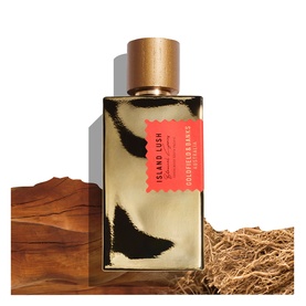 Goldfield & Banks Island Lush EDP in gold and black rectangular bottle with wooden cap, styled with wood and dried botanicals