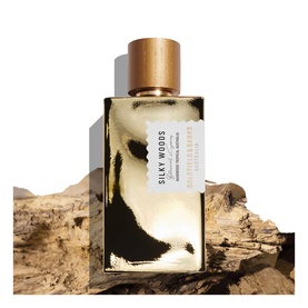 Goldfield & Banks Silky Woods EDP in glass bottle with gold cap, displayed on natural wood bark background