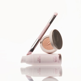 Kylie Cosmetics brush in blush pink with matching eyeshadow compact and tube, displayed upright on white background